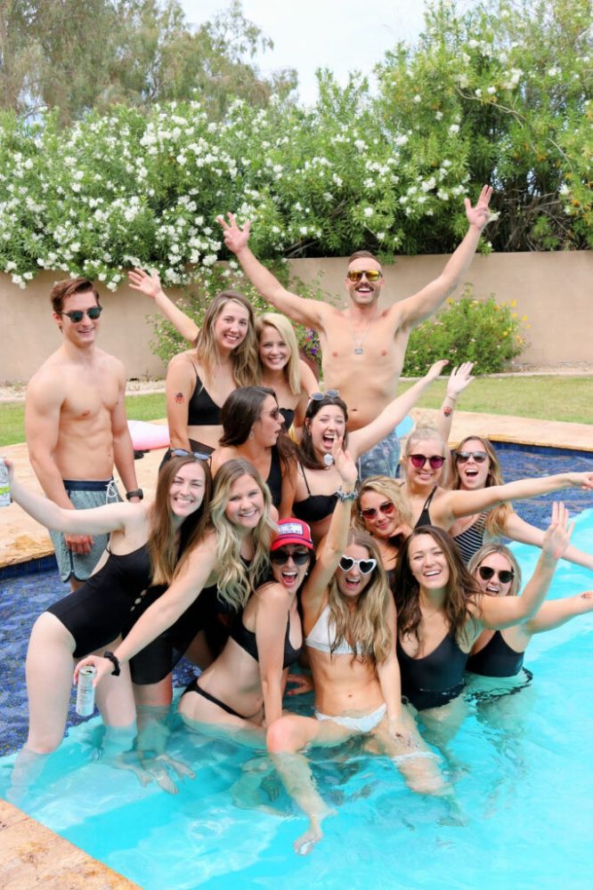 a group of people swimming in a body of water posing for the camera