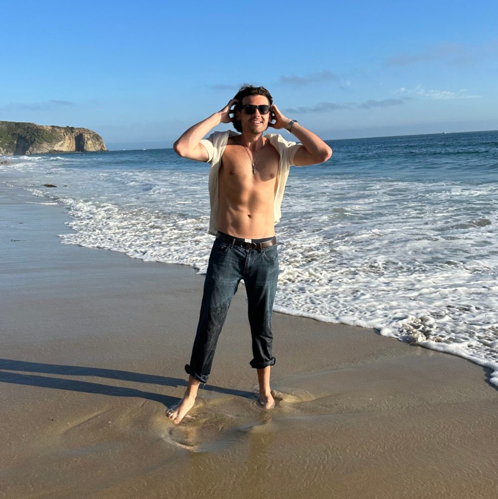 a person standing on top of a sandy beach