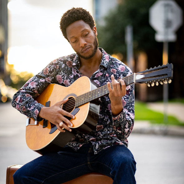 a man holding a guitar