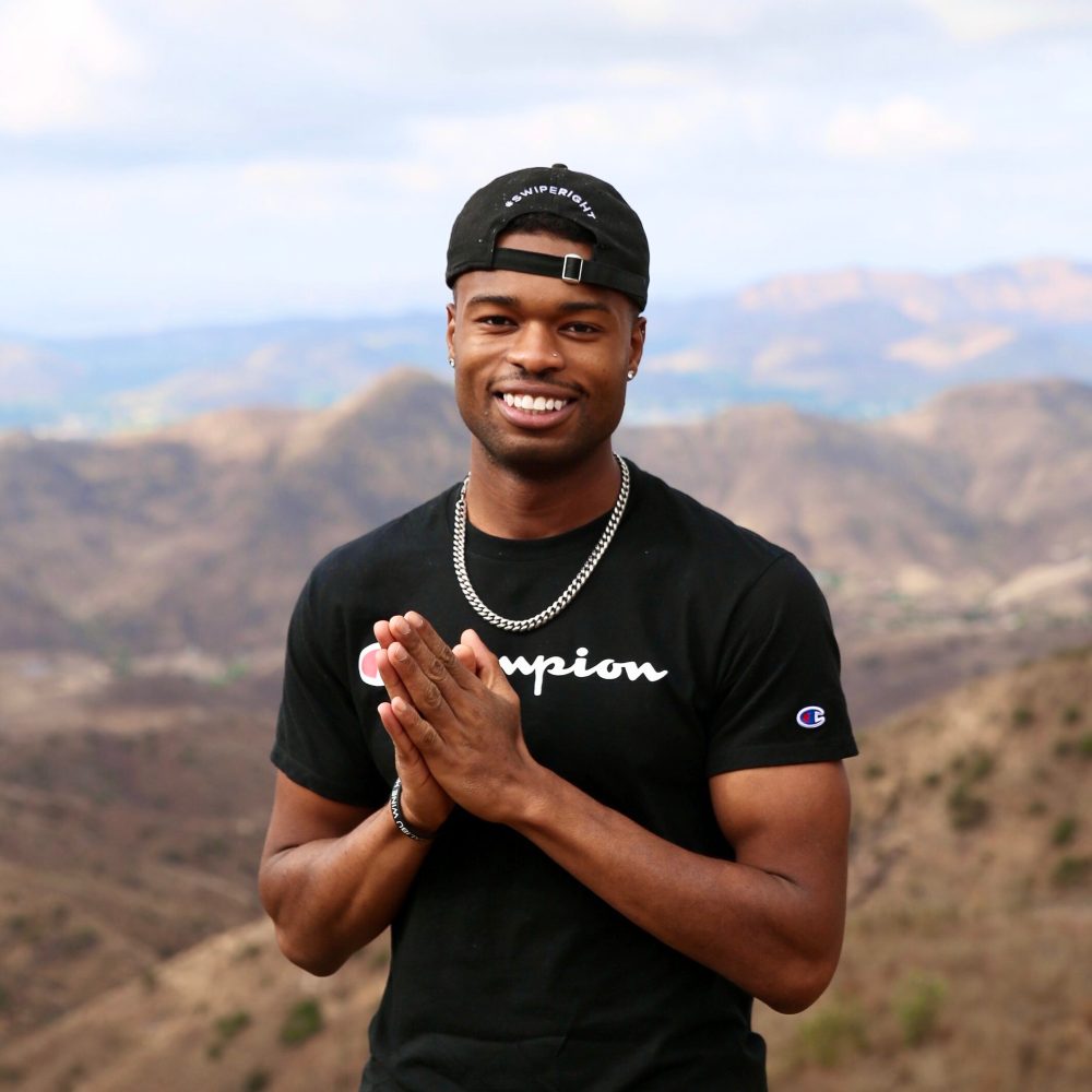 a man holding up a mountain in the background