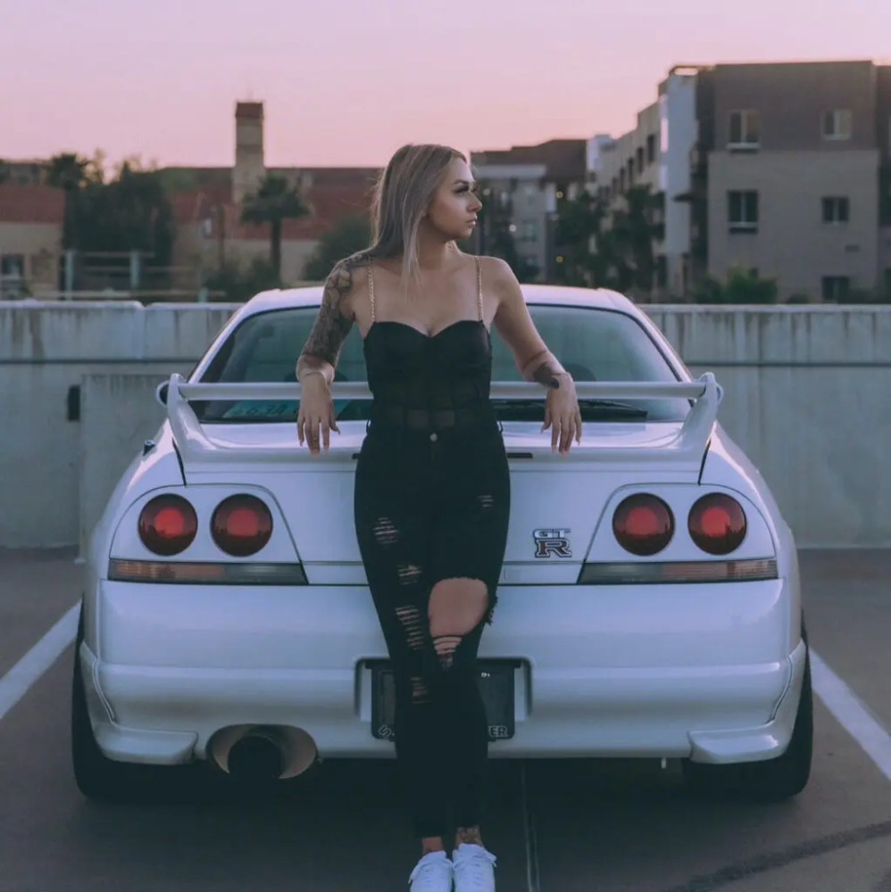 a person standing in front of a car