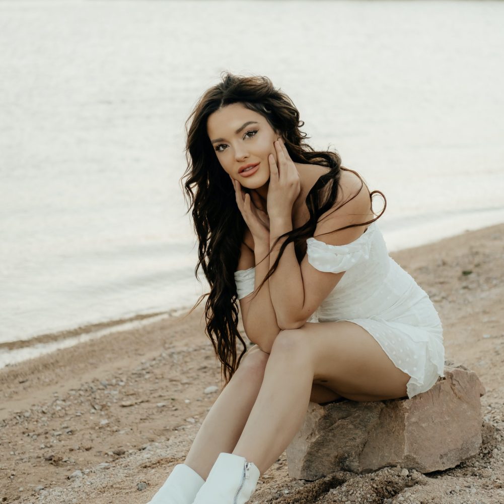 a woman sitting at a beach