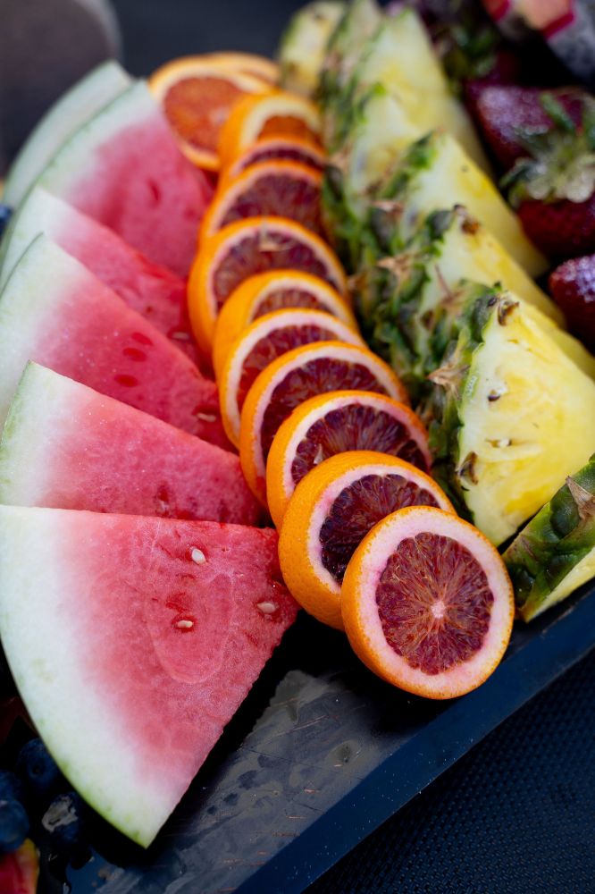 a plate of food with a slice of fresh fruit