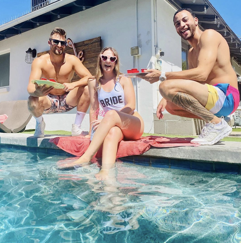 a group of people swimming in a pool of water